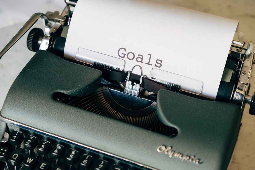 Old fashioned typewriter with a white sheet of paper with the word 'Goals' typed on it